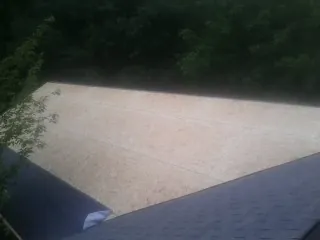 New OSB roof sheathing installed beside an existing shingle roof in Ridgefield